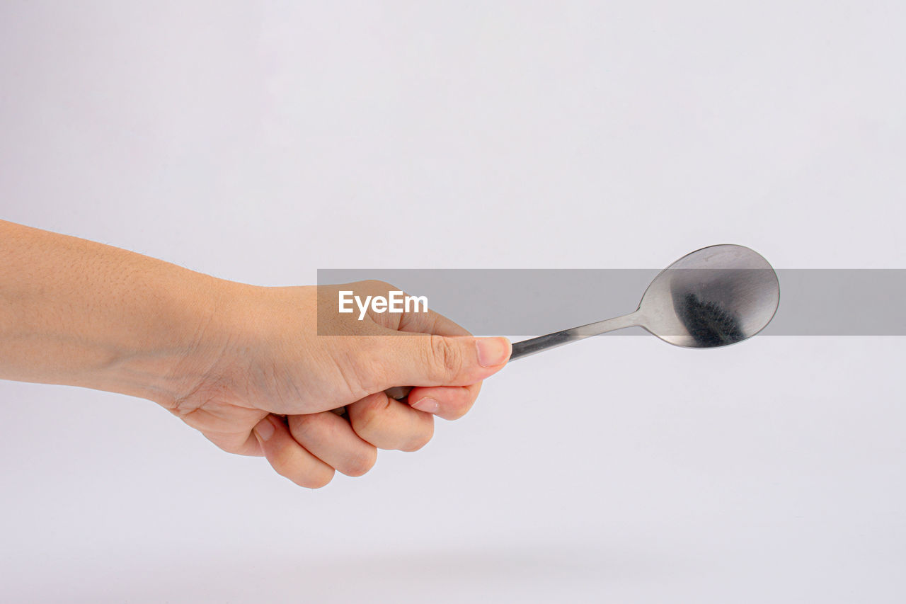 hand, kitchen utensil, spoon, studio shot, indoors, adult, holding, silverware, one person, tableware, close-up, women, copy space