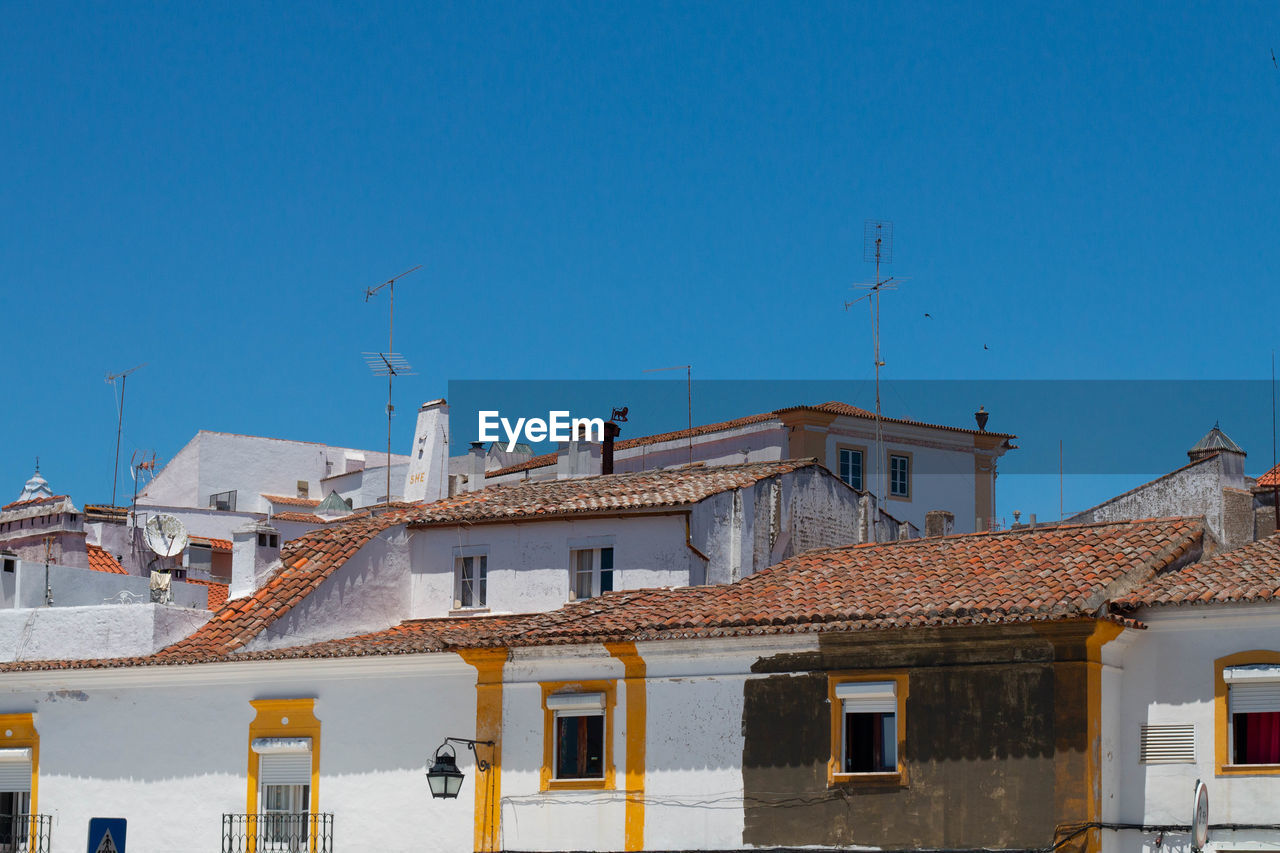 BUILDINGS AGAINST BLUE SKY