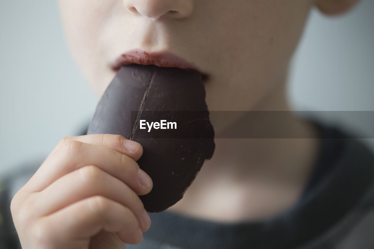 Close-up of boy eating chocolate