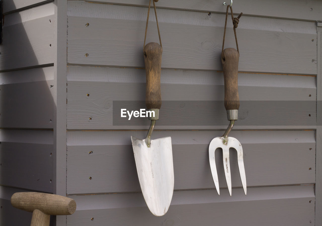 CLOSE-UP OF WOOD HANGING ON WOODEN WALL