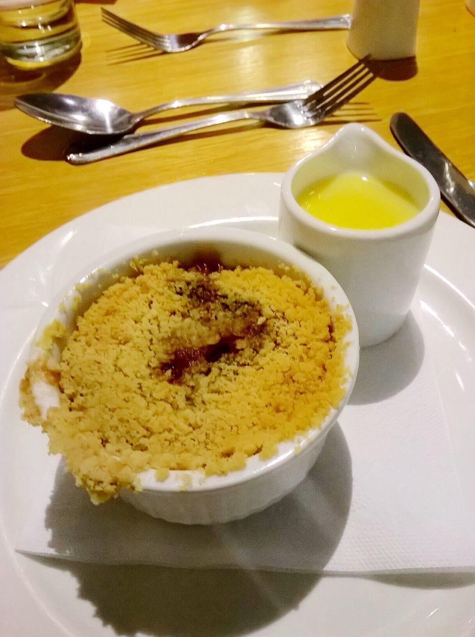 High angle view of apple crumble served in plate on table at restaurant