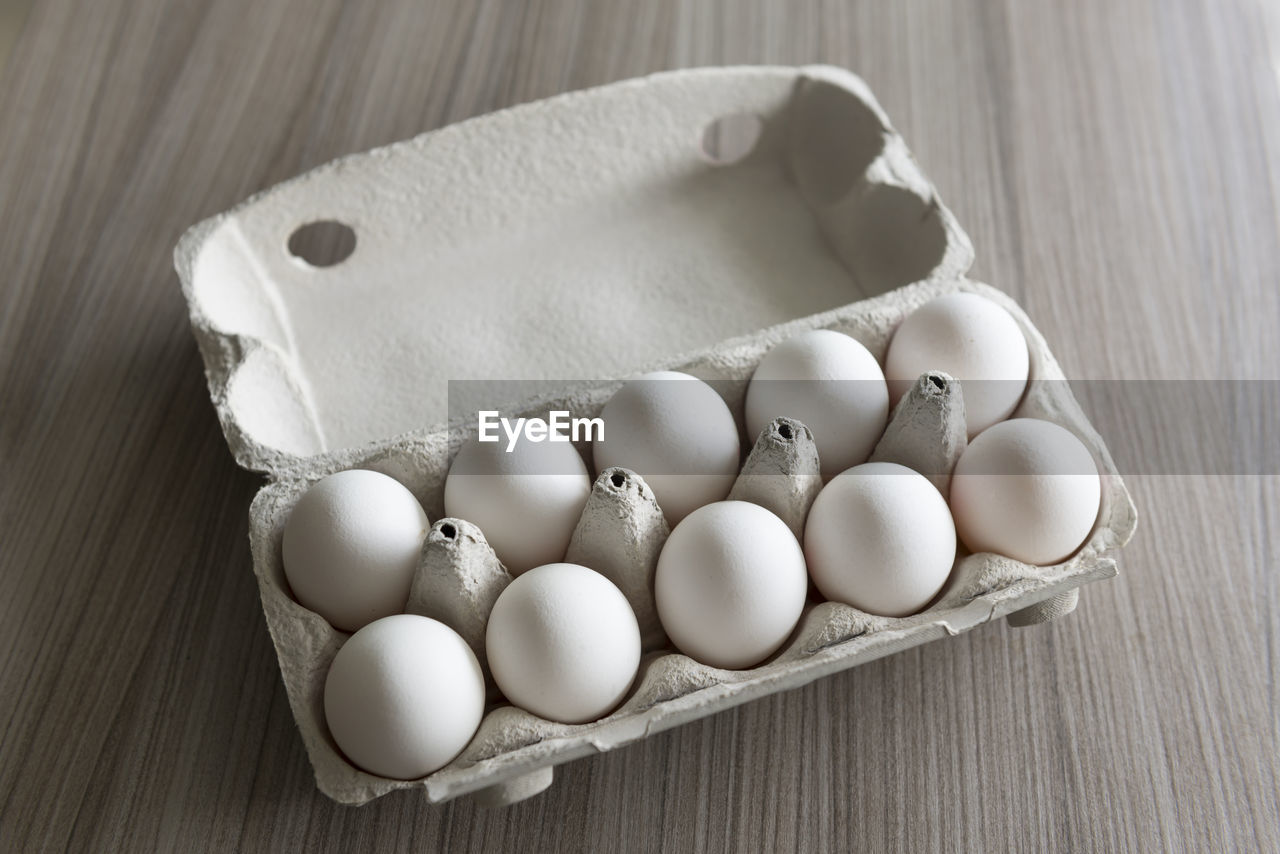 High angle view of eggs in crate on table