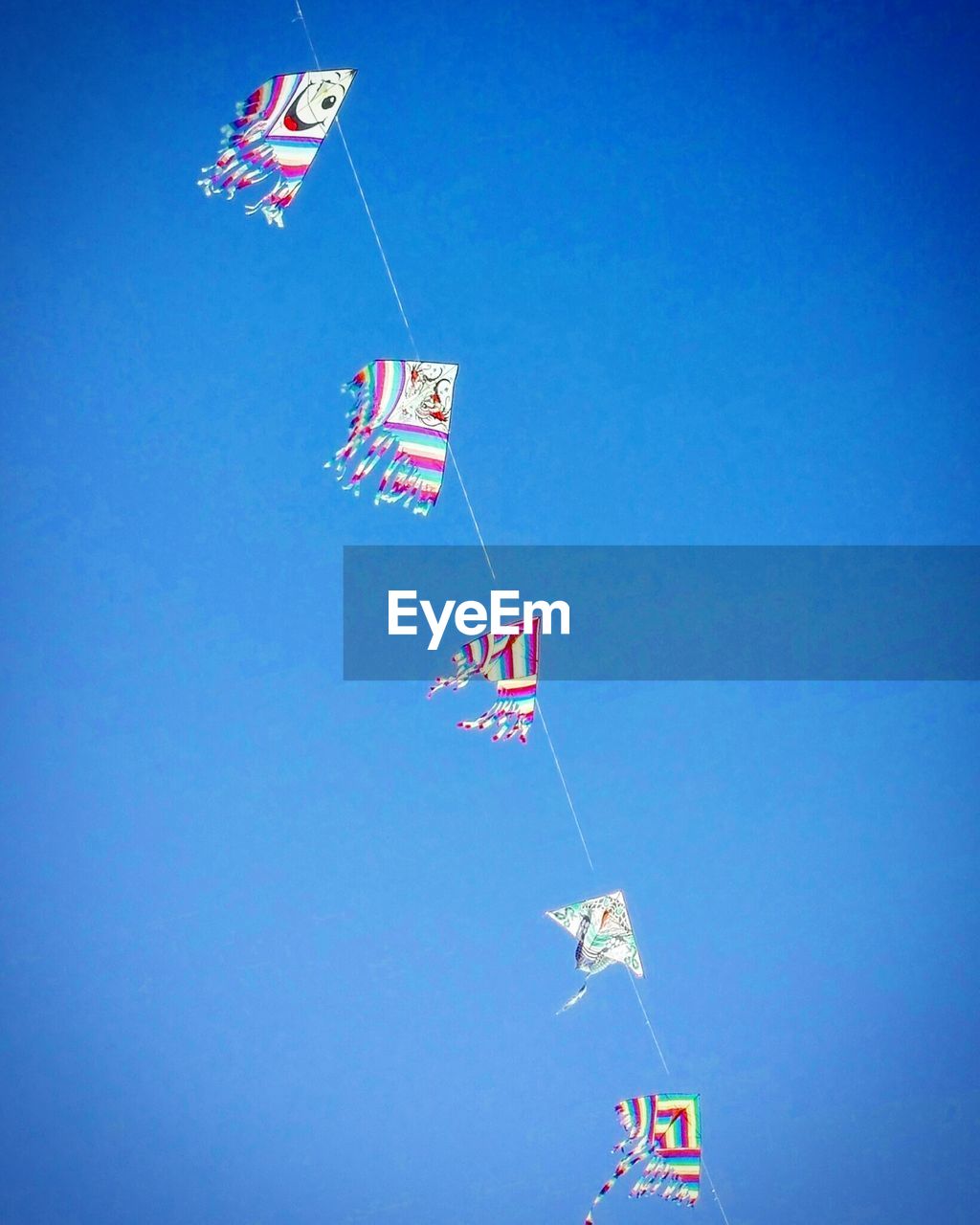 LOW ANGLE VIEW OF FLAGS HANGING AGAINST CLEAR SKY