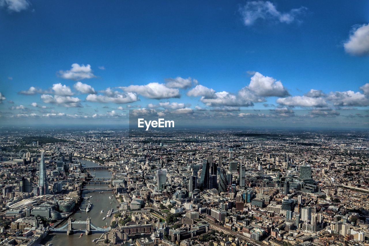 Aerial view of cityscape with thames river against sky