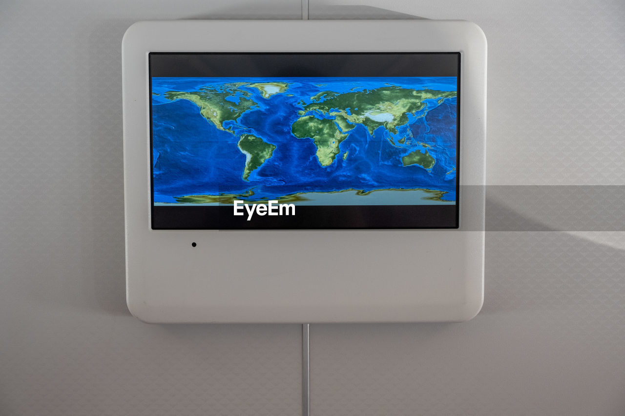 Close-up of device screen in airplane