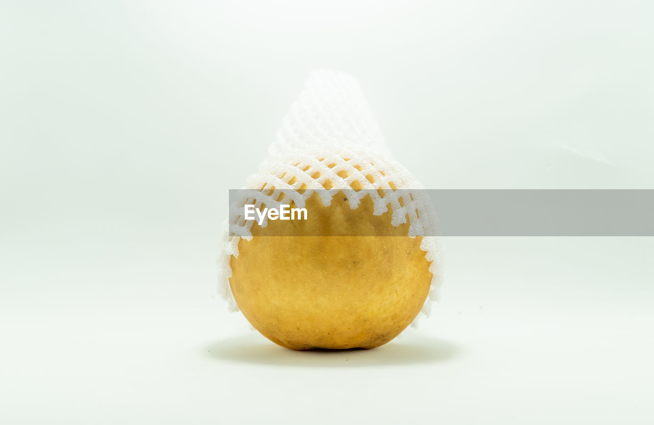 CLOSE-UP OF FRUIT AGAINST WHITE BACKGROUND