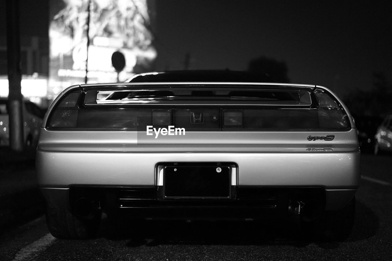 CLOSE-UP OF CAR ON STREET