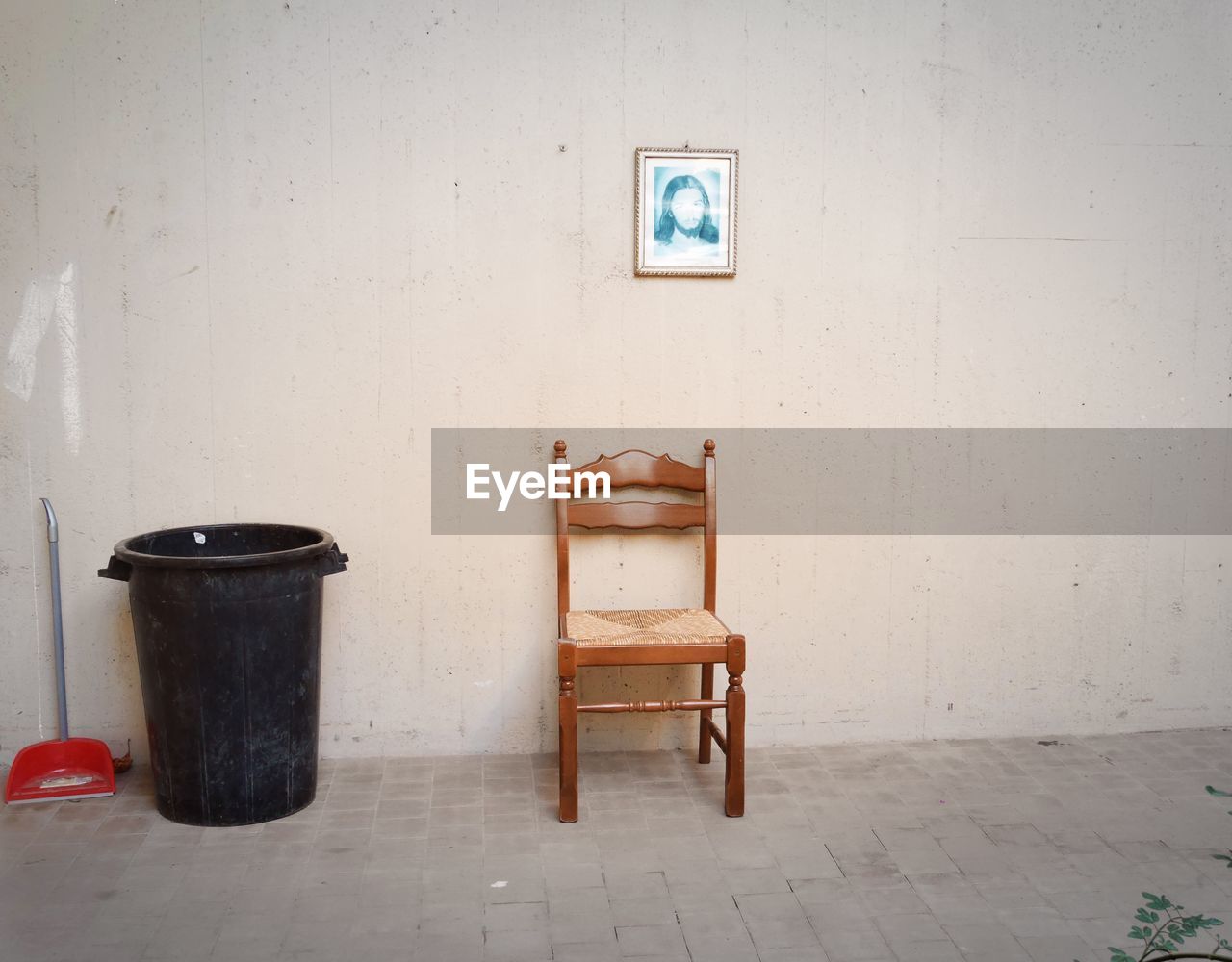 EMPTY CHAIRS AND TABLE AGAINST WALL