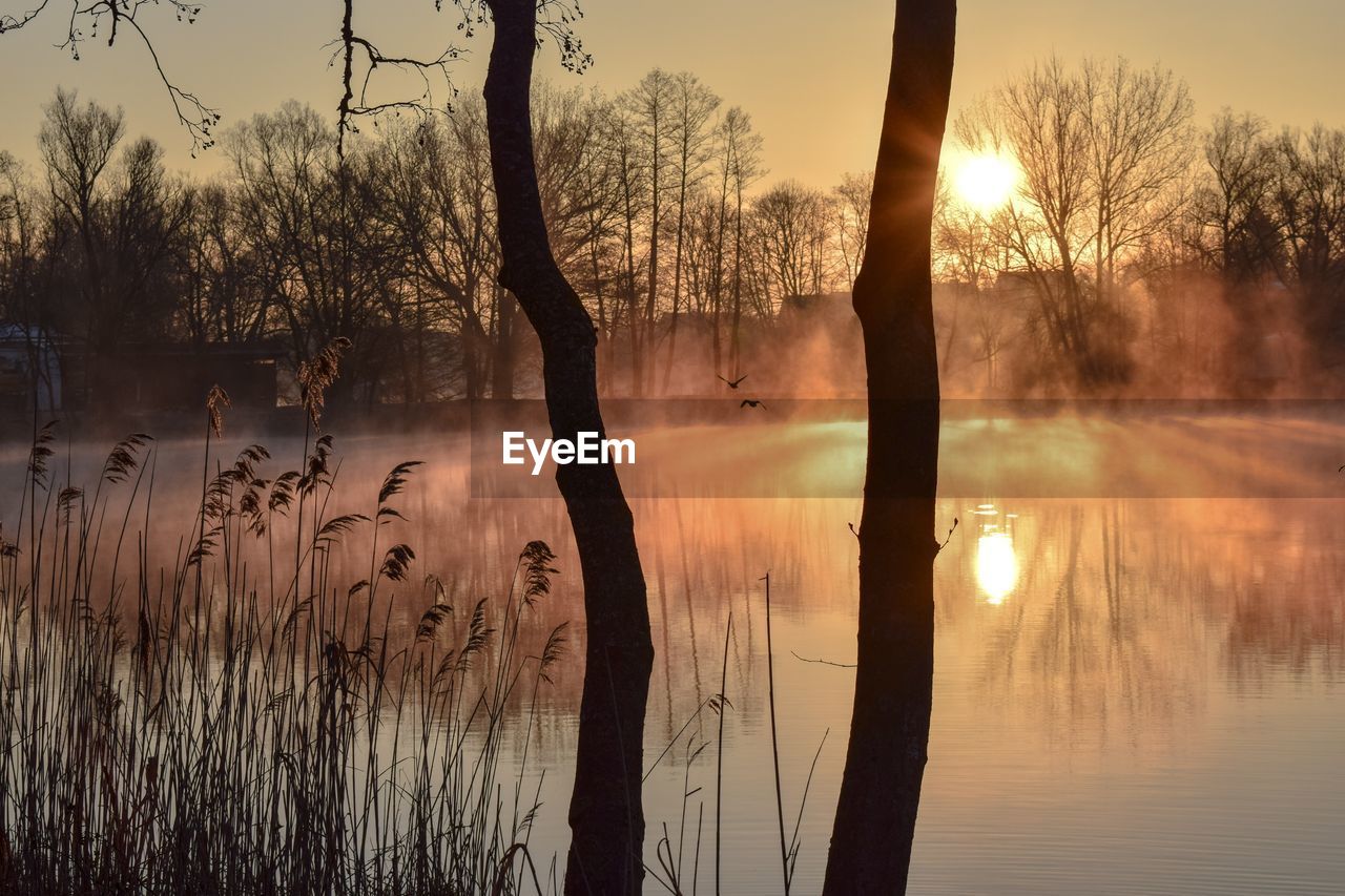 Scenic view of lake against sky during sunset