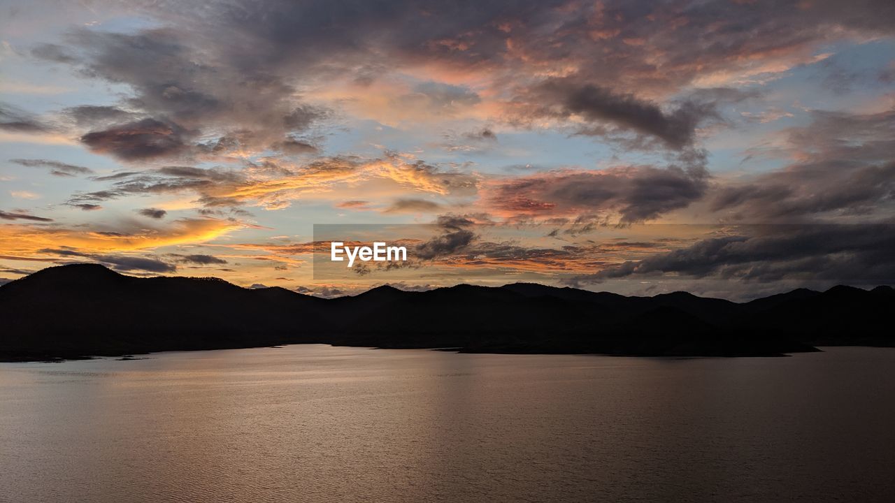 Scenic view of lake against sky during sunset