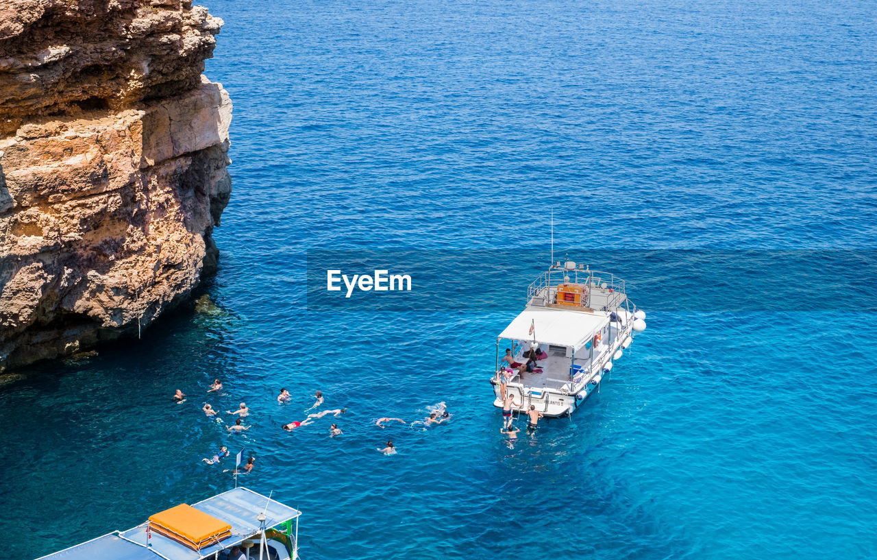 HIGH ANGLE VIEW OF SAILBOATS ON SEA