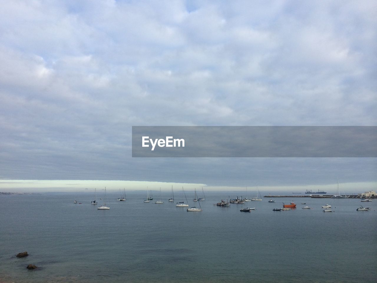 Boats sailing in sea against sky
