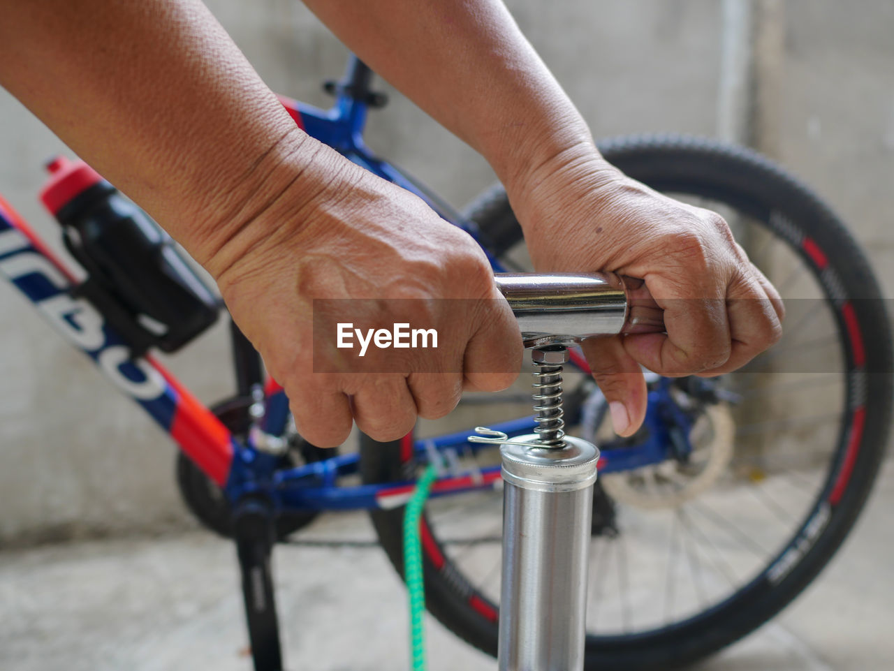 Close-up of person filling bicycle tire