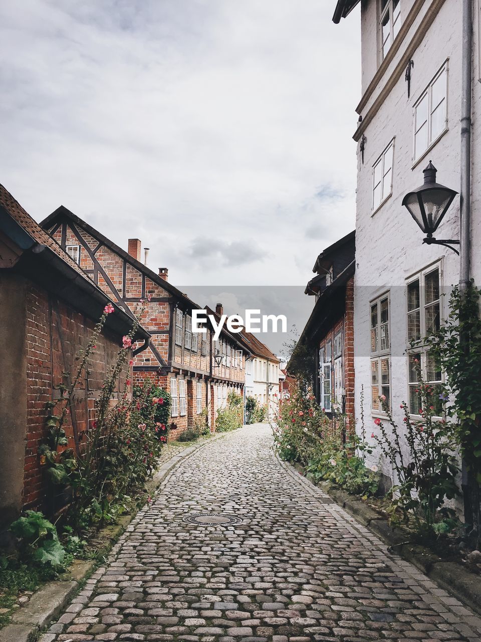 COBBLESTONE STREET AGAINST SKY