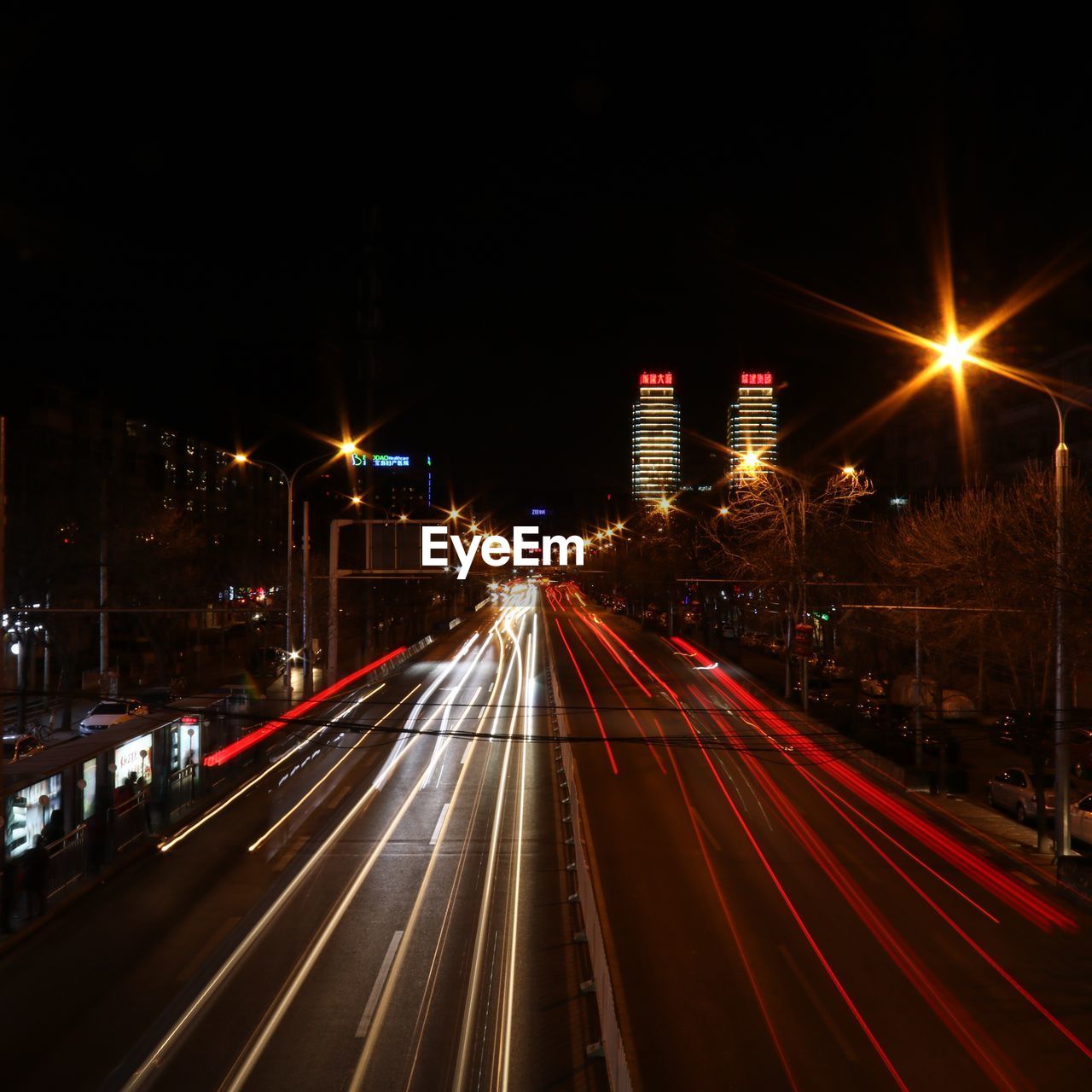 LIGHT TRAILS ON ROAD ALONG BUILDINGS