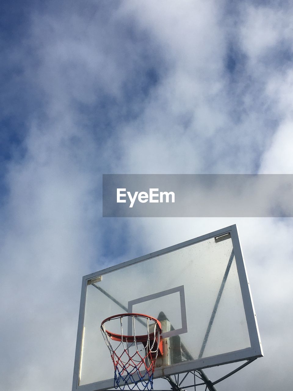 low angle view of basketball hoop against clouds