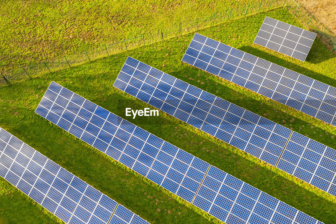 High angle view of solar panels on grassy field