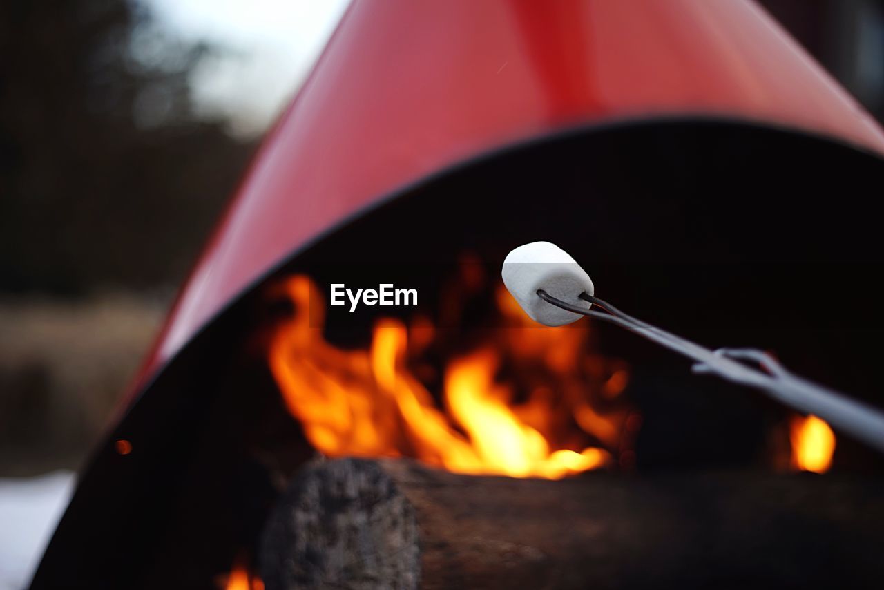 Close-up of marshmallow against fire