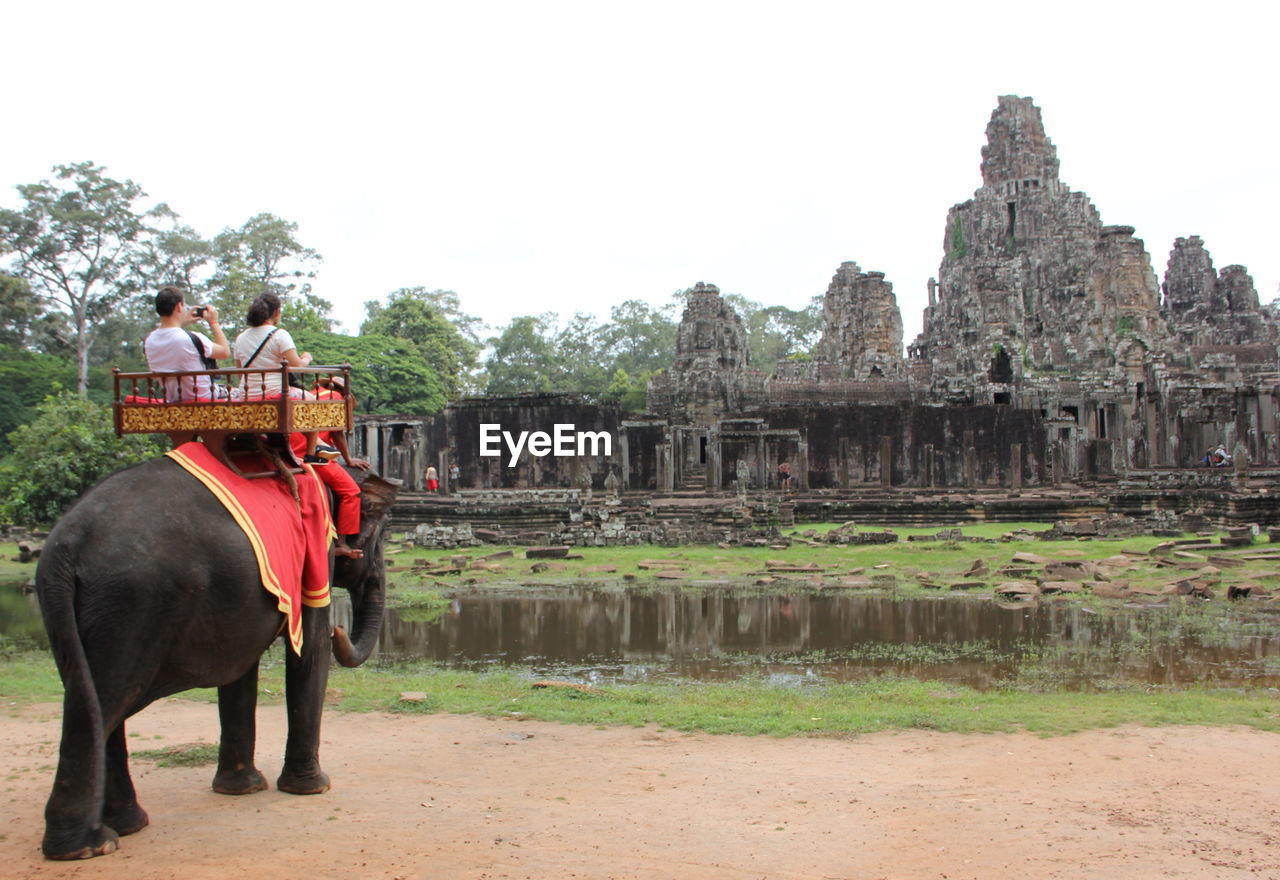 PEOPLE SITTING ON TEMPLE