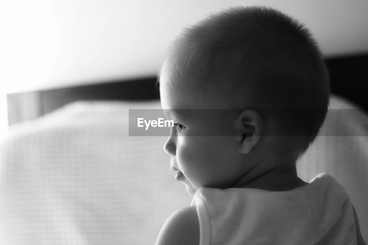 Close-up portrait of boy looking away at home