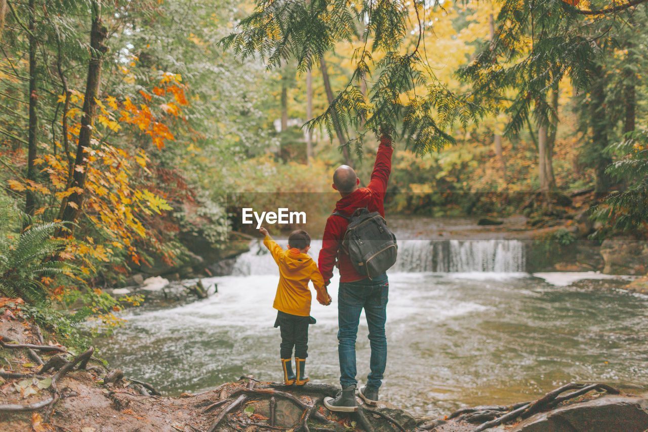 Full length of father and son in forest