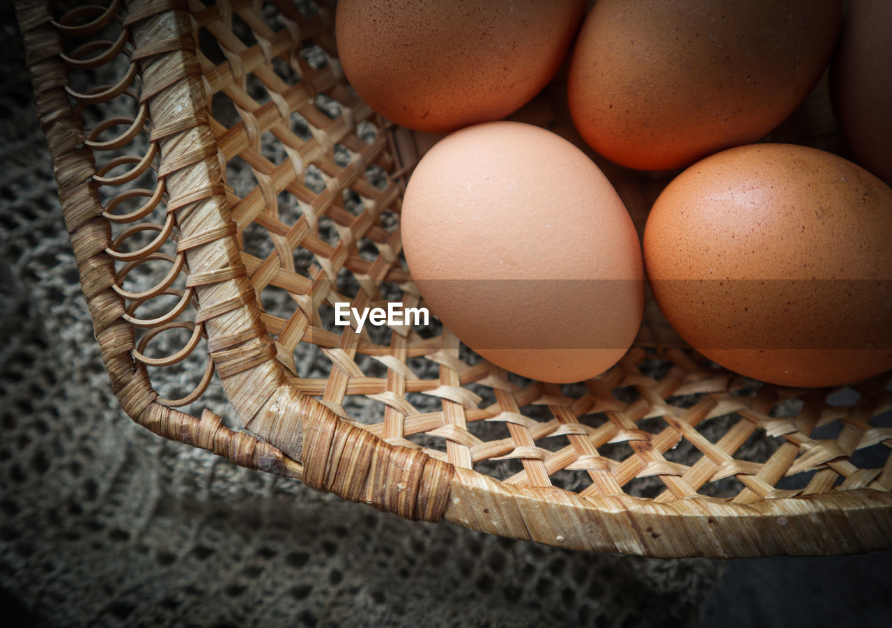 HIGH ANGLE VIEW OF EGGS IN BASKET ON WICKER