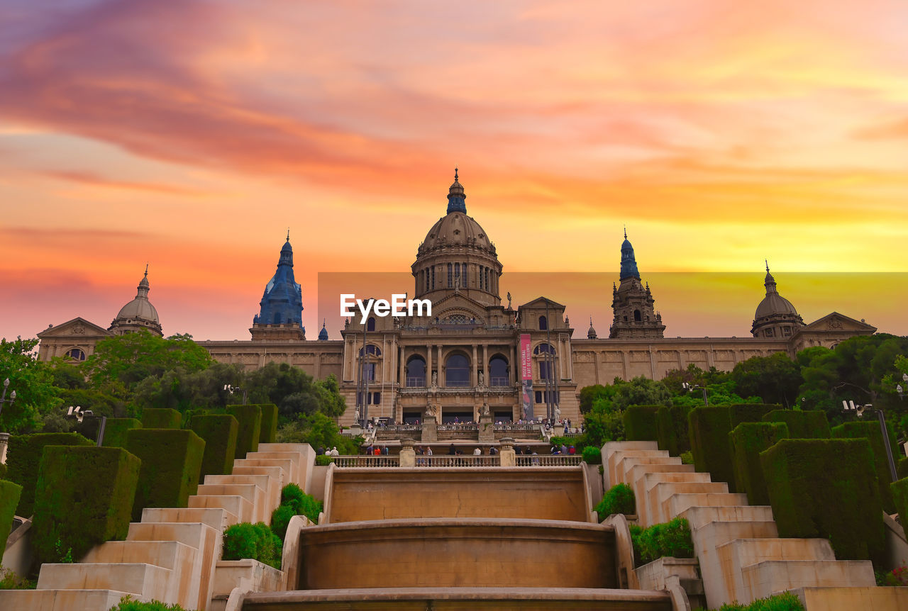 TEMPLE AGAINST BUILDING DURING SUNSET