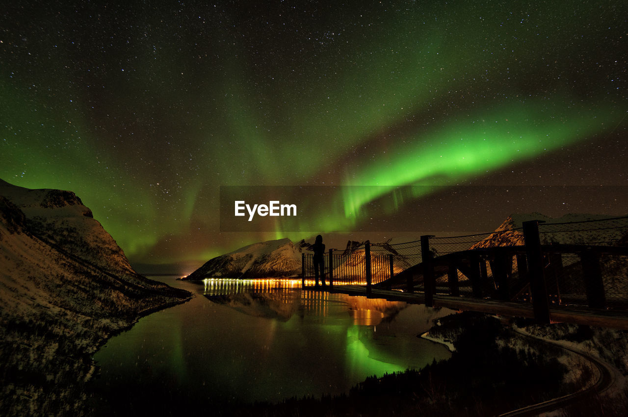 Scenic view of lake against sky at night