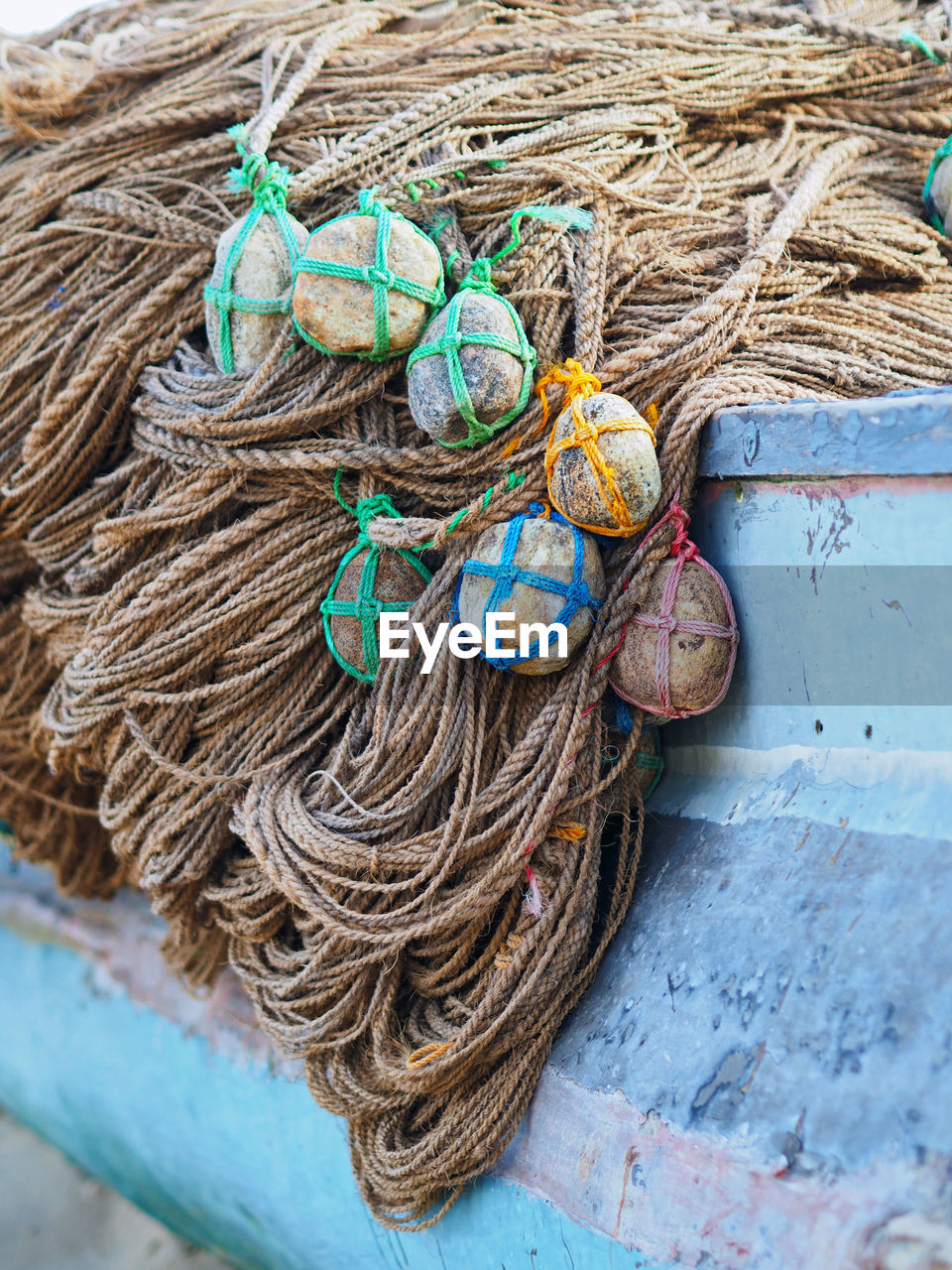 Pile of stones tied on ropes in boat