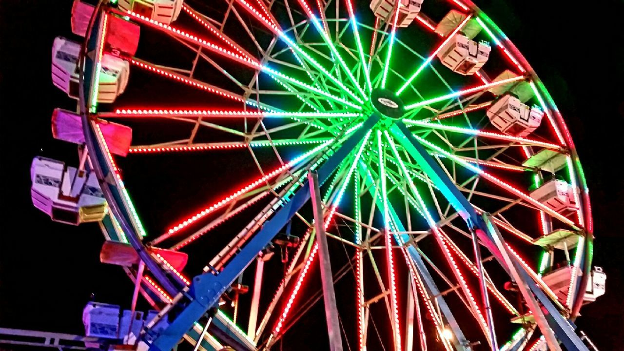 LOW ANGLE VIEW OF FERRIS WHEEL AT NIGHT