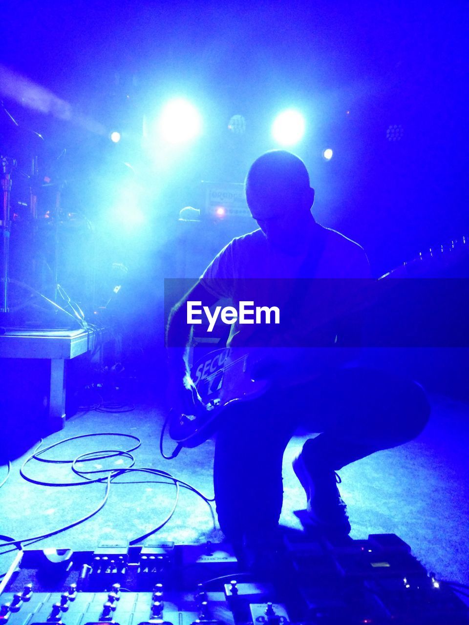 Close-up of man playing electric guitar