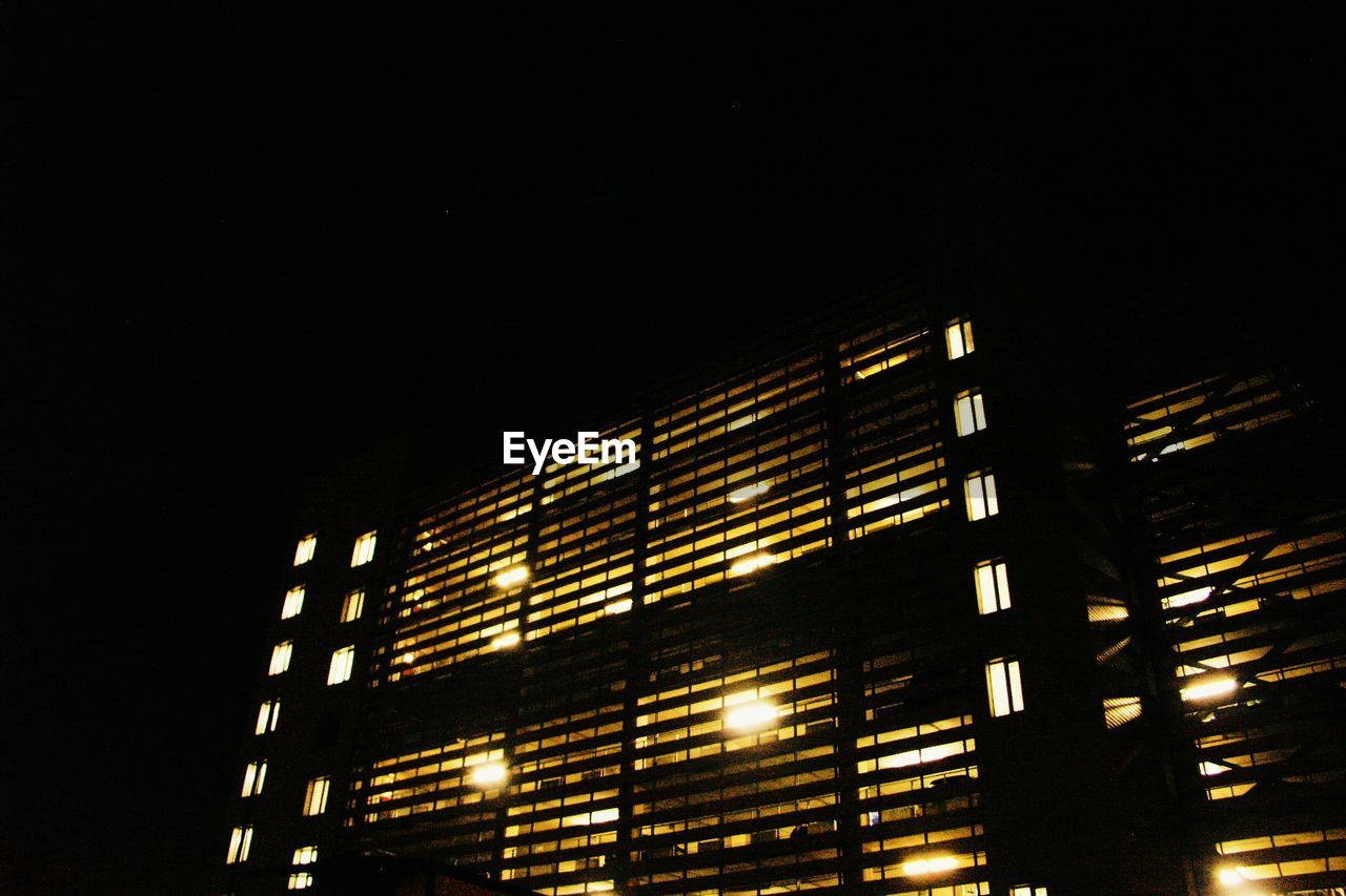 Low angle view of building lit up at night