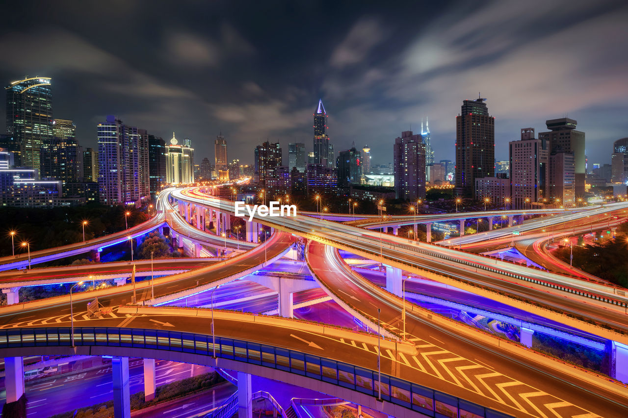 ILLUMINATED BRIDGE AND BUILDINGS AT NIGHT