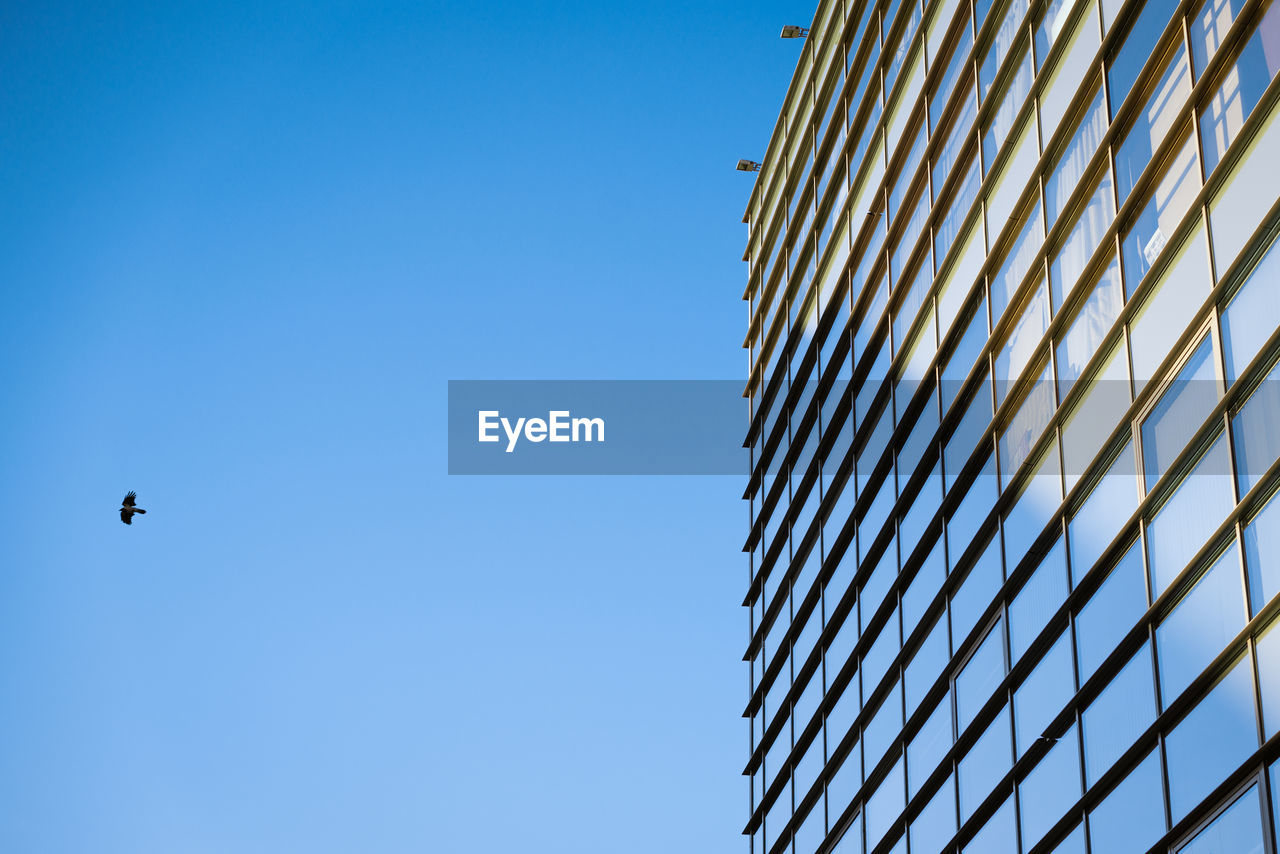 Glass building facade with sky reflection