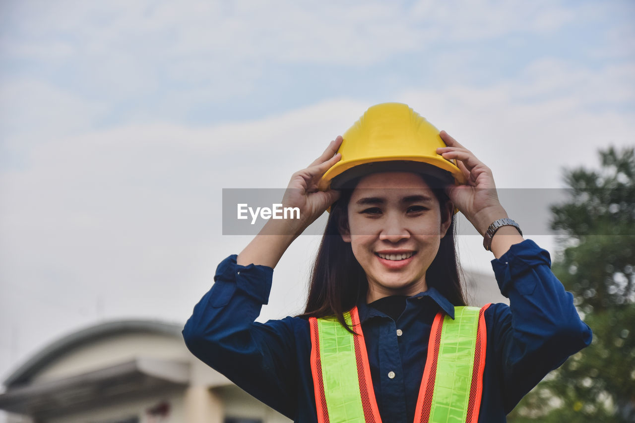 Asian woman engineering yellow helmet hard hat safety