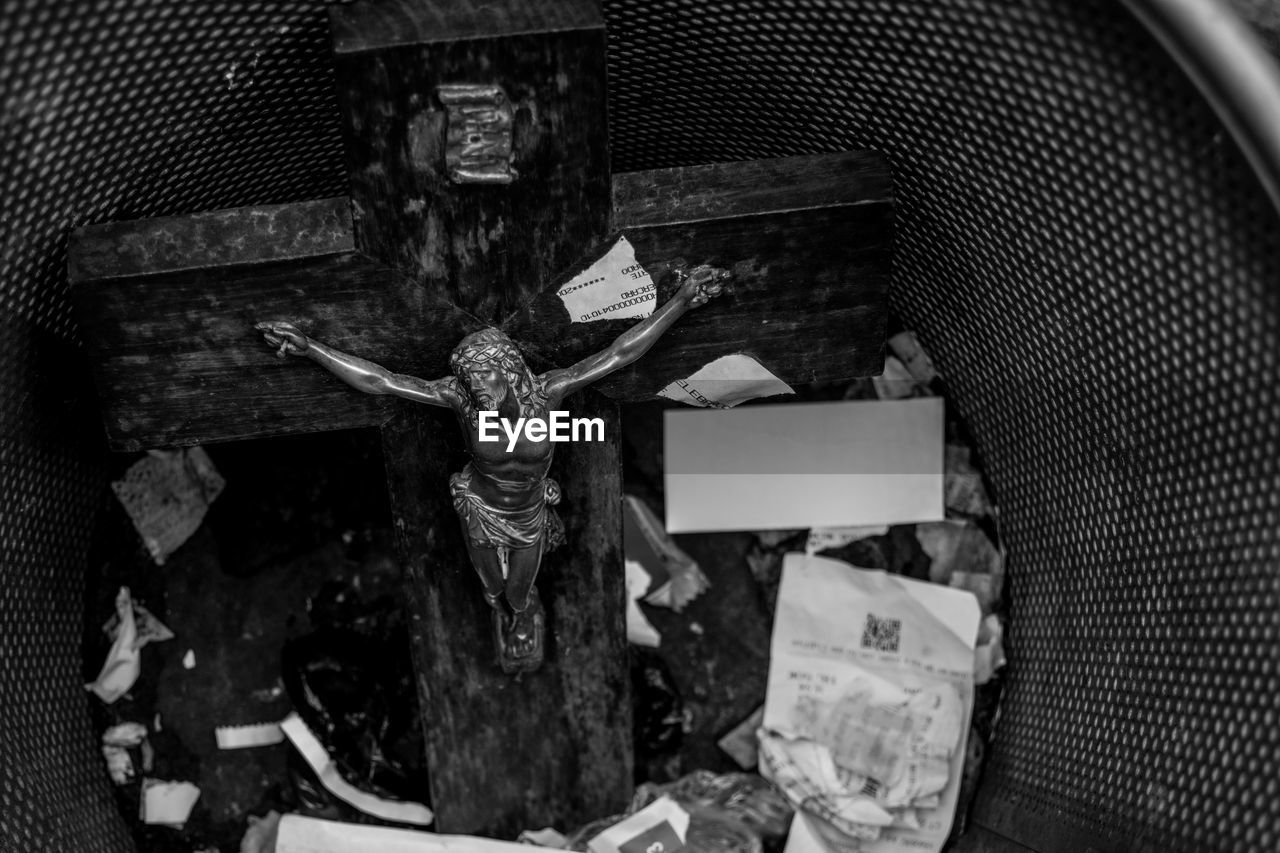 High angle view of crucifix in garbage bin