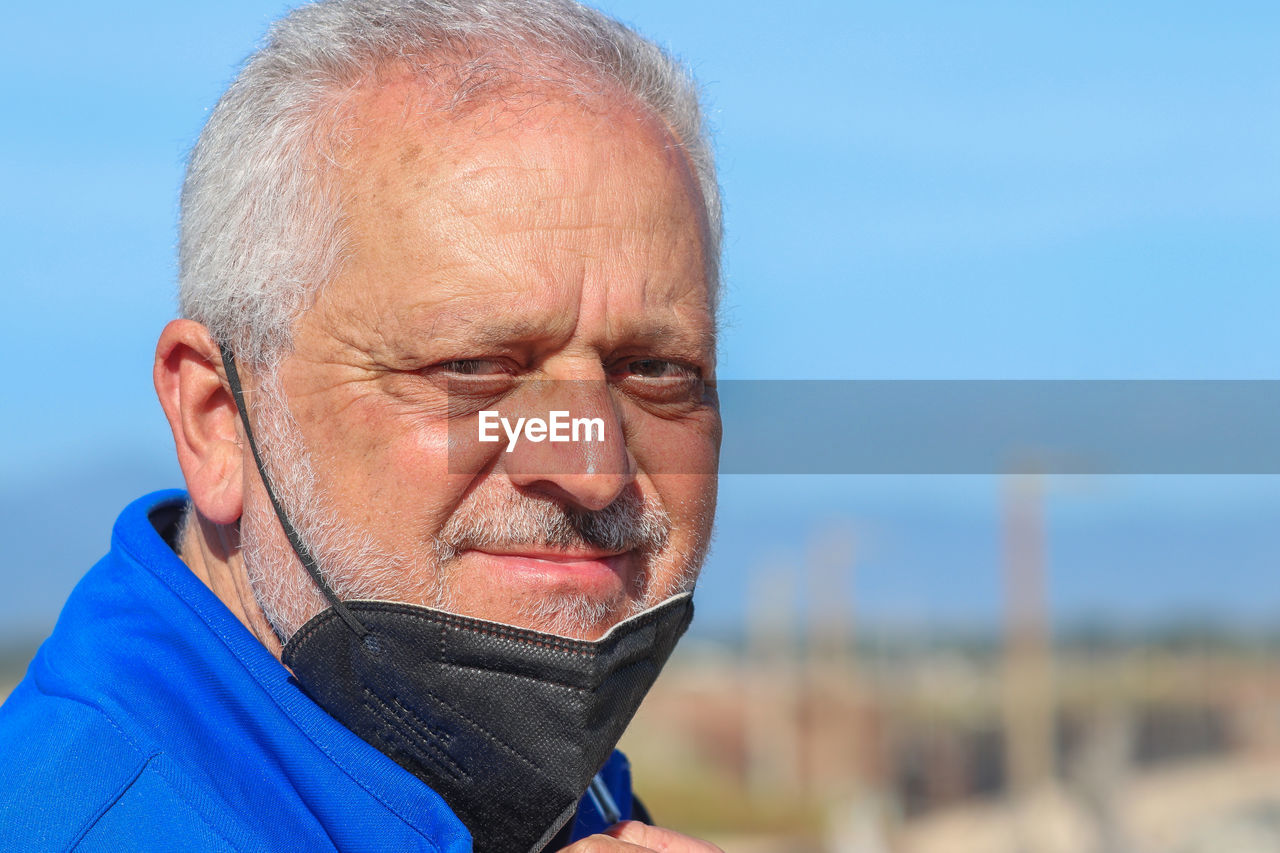 Portrait of man wearing protective face mask outdoors