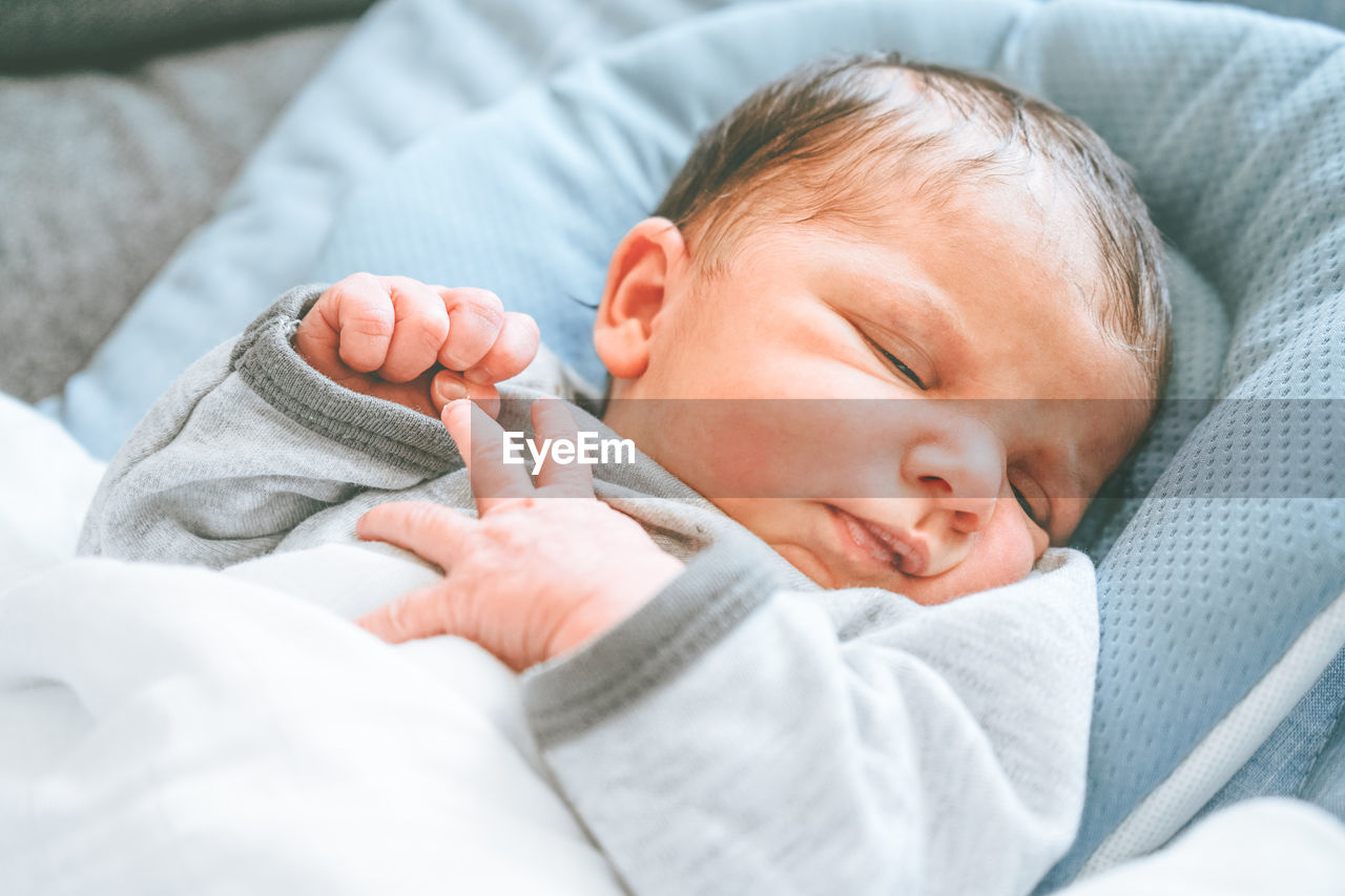 Cute baby lying on bed at home