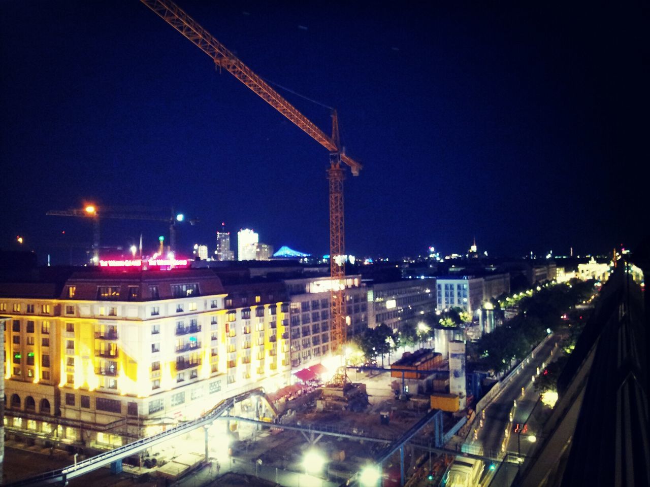 VIEW OF ILLUMINATED CITYSCAPE AT NIGHT