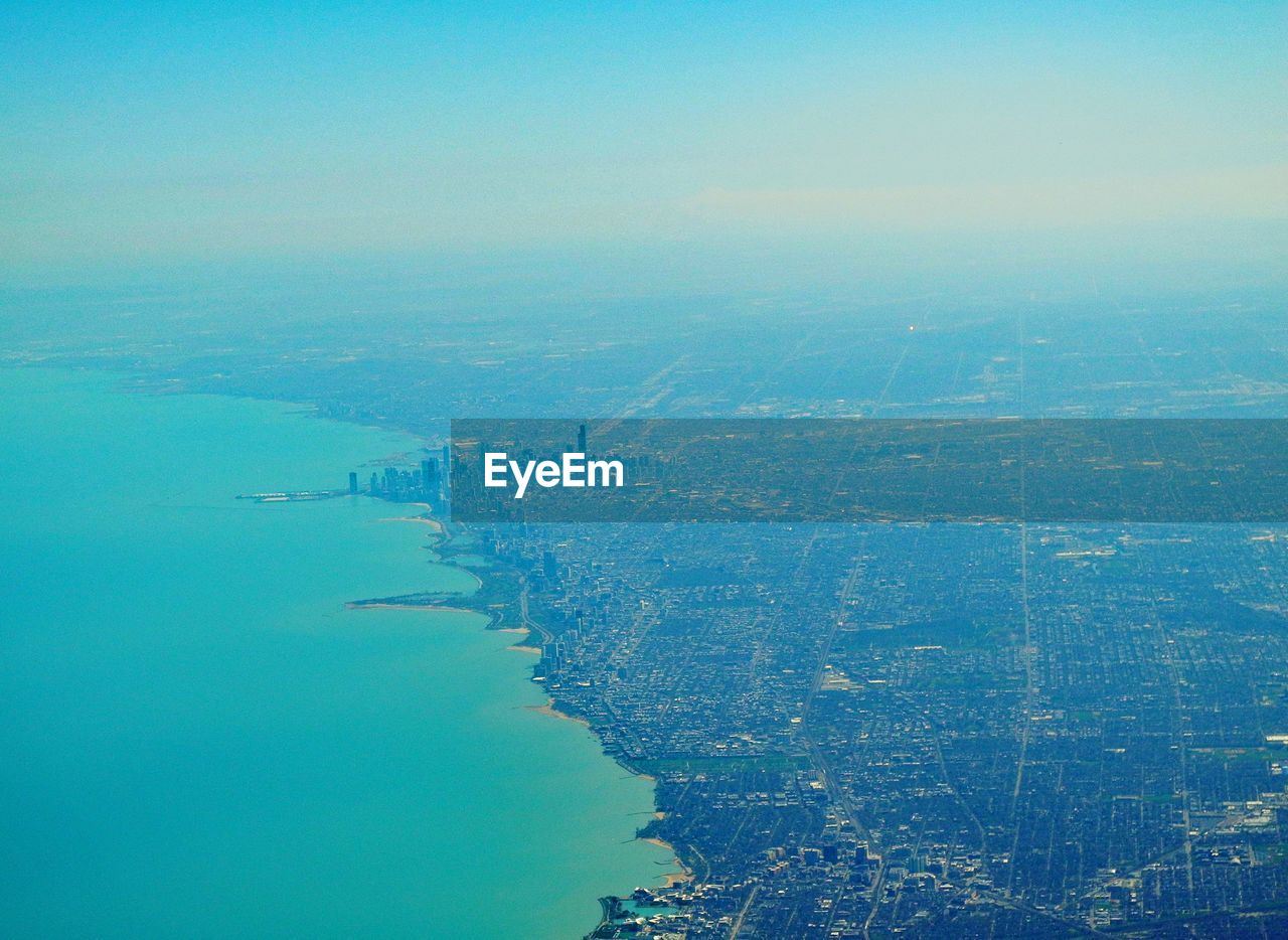 AERIAL VIEW OF SEA AGAINST BLUE SKY