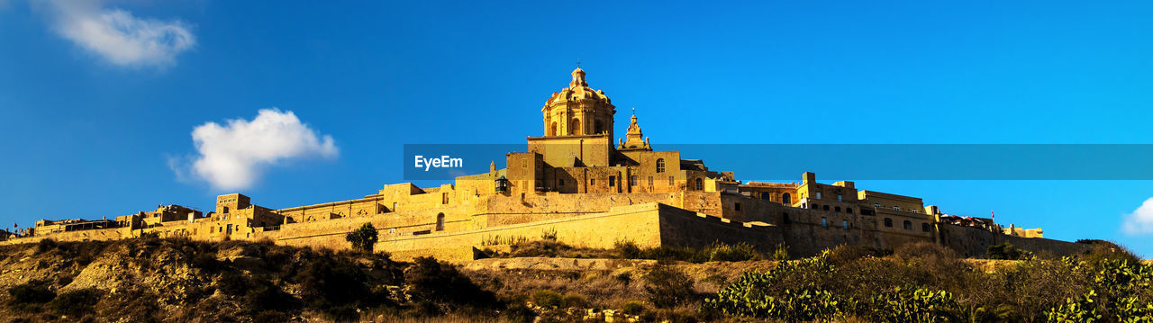 architecture, sky, built structure, building exterior, travel destinations, history, the past, castle, landmark, building, nature, blue, travel, château, cloud, tourism, religion, no people, plant, tree, tower, landscape, ancient, outdoors, old, fort, city, place of worship, panoramic, medieval, historic site, low angle view, belief, land, scenics - nature, clear sky, sunlight, day, sunny