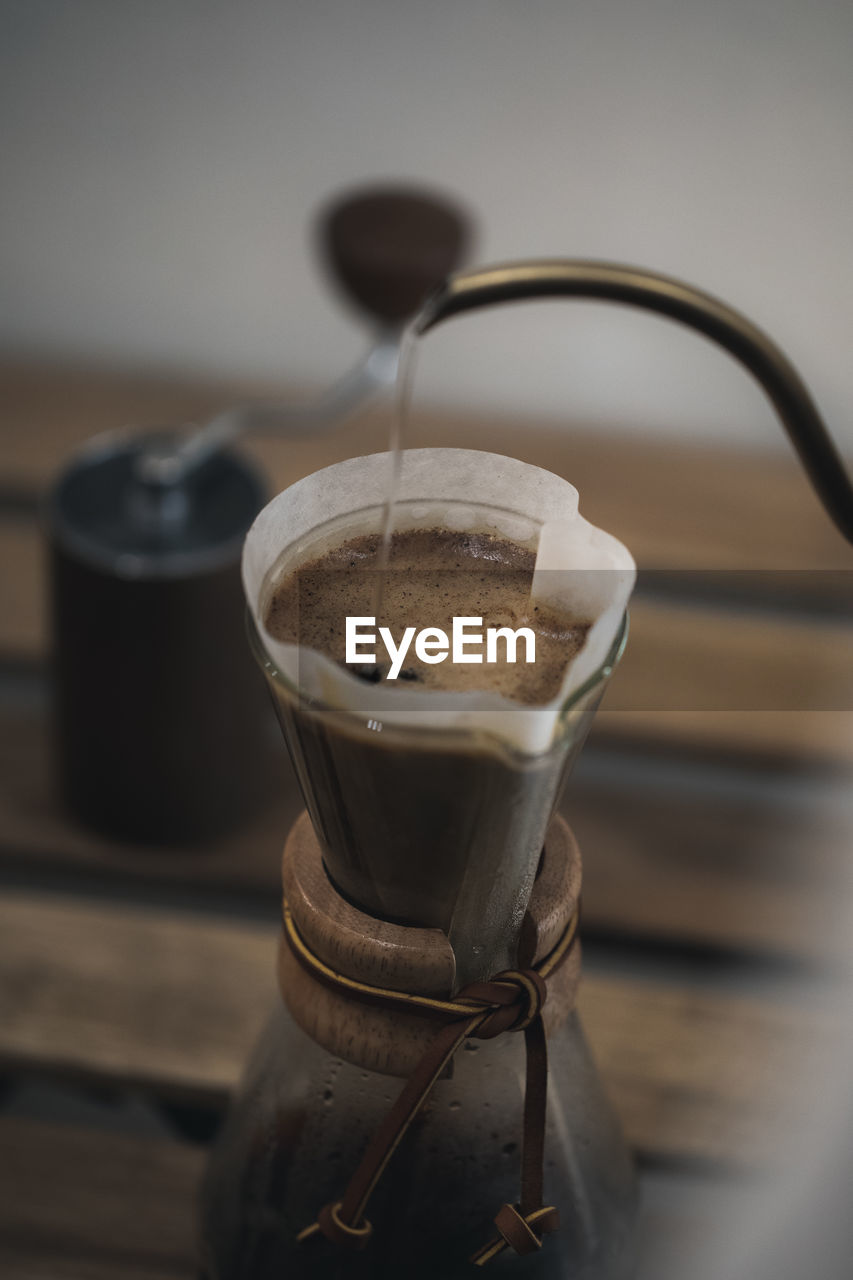 CLOSE-UP OF COFFEE CUP ON GLASS