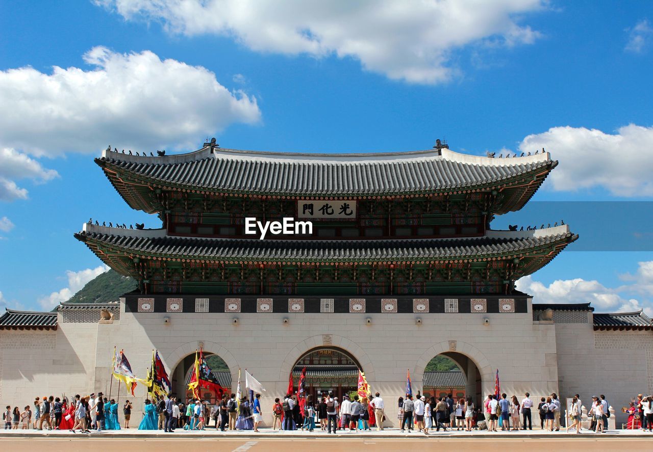 People at gyeongbokgung against sky