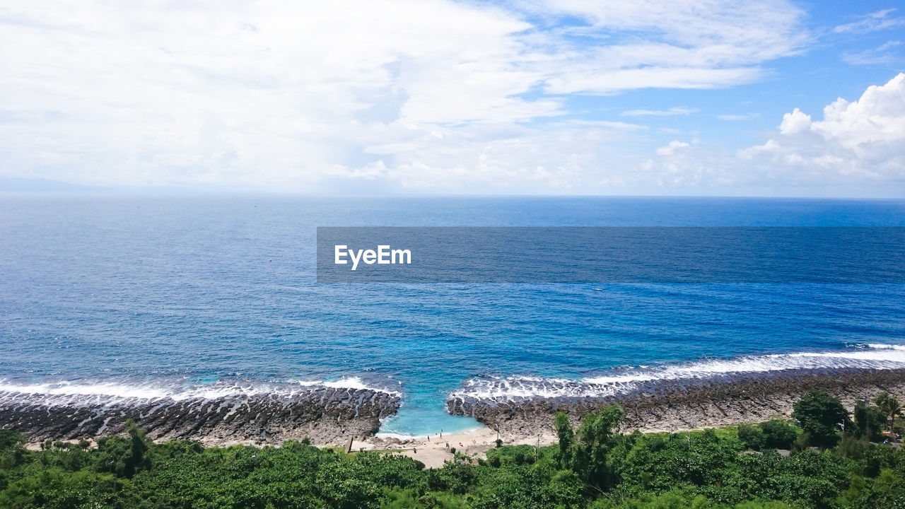 Scenic view of sea against cloudy sky