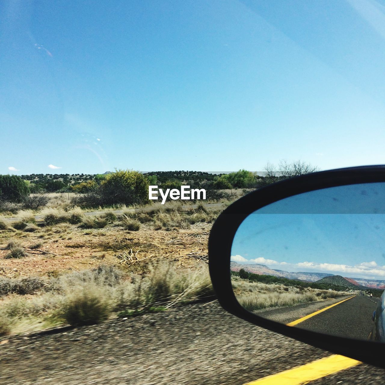 View of side-view mirror against clear sky