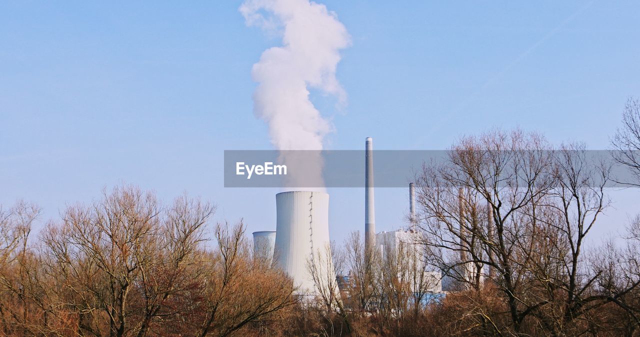 SMOKE STACKS AGAINST SKY