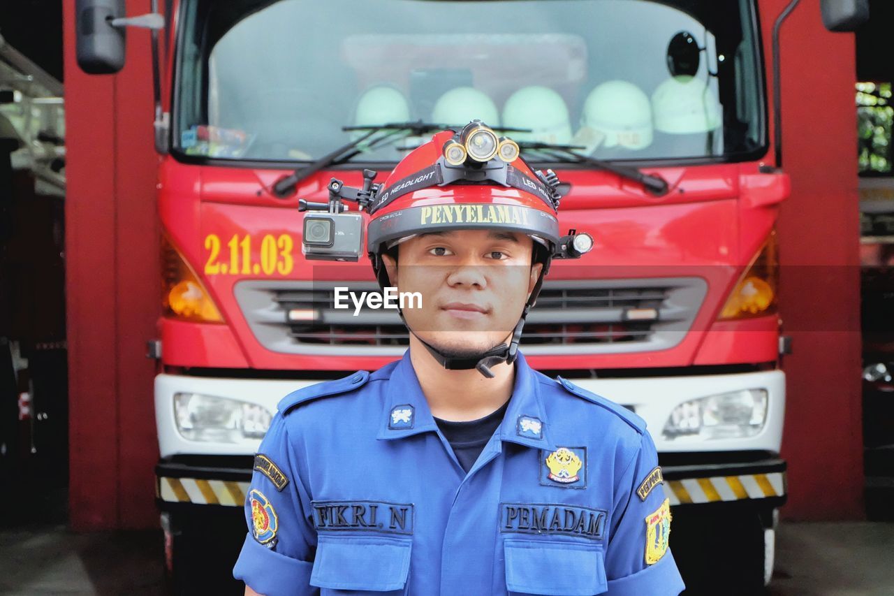 Firefighter standing in front of fire engine