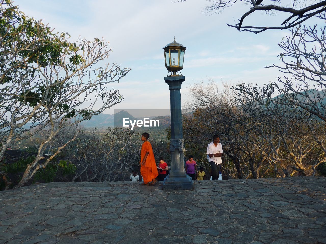 People on mountain against sky