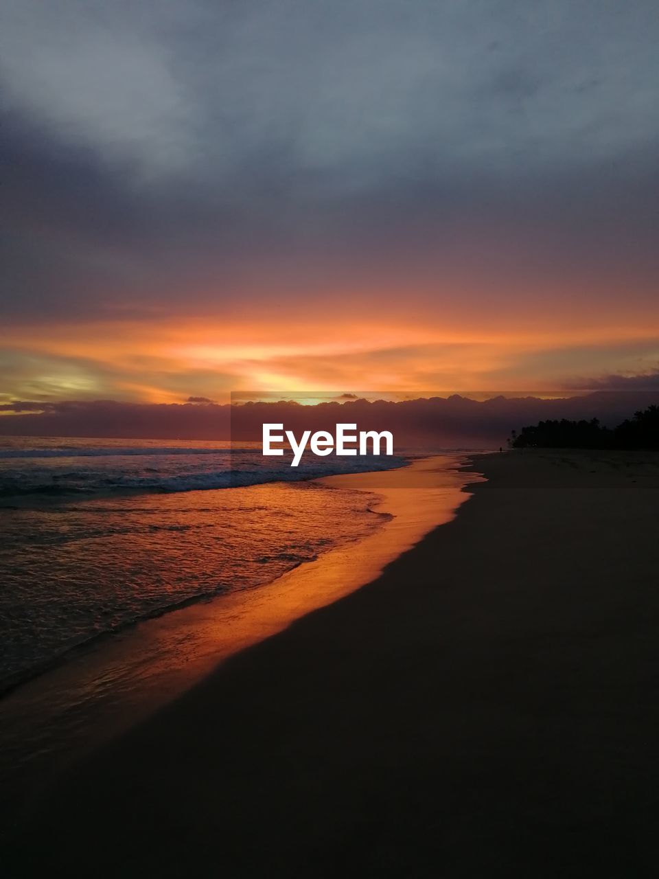 Scenic view of sea against romantic sky at sunset