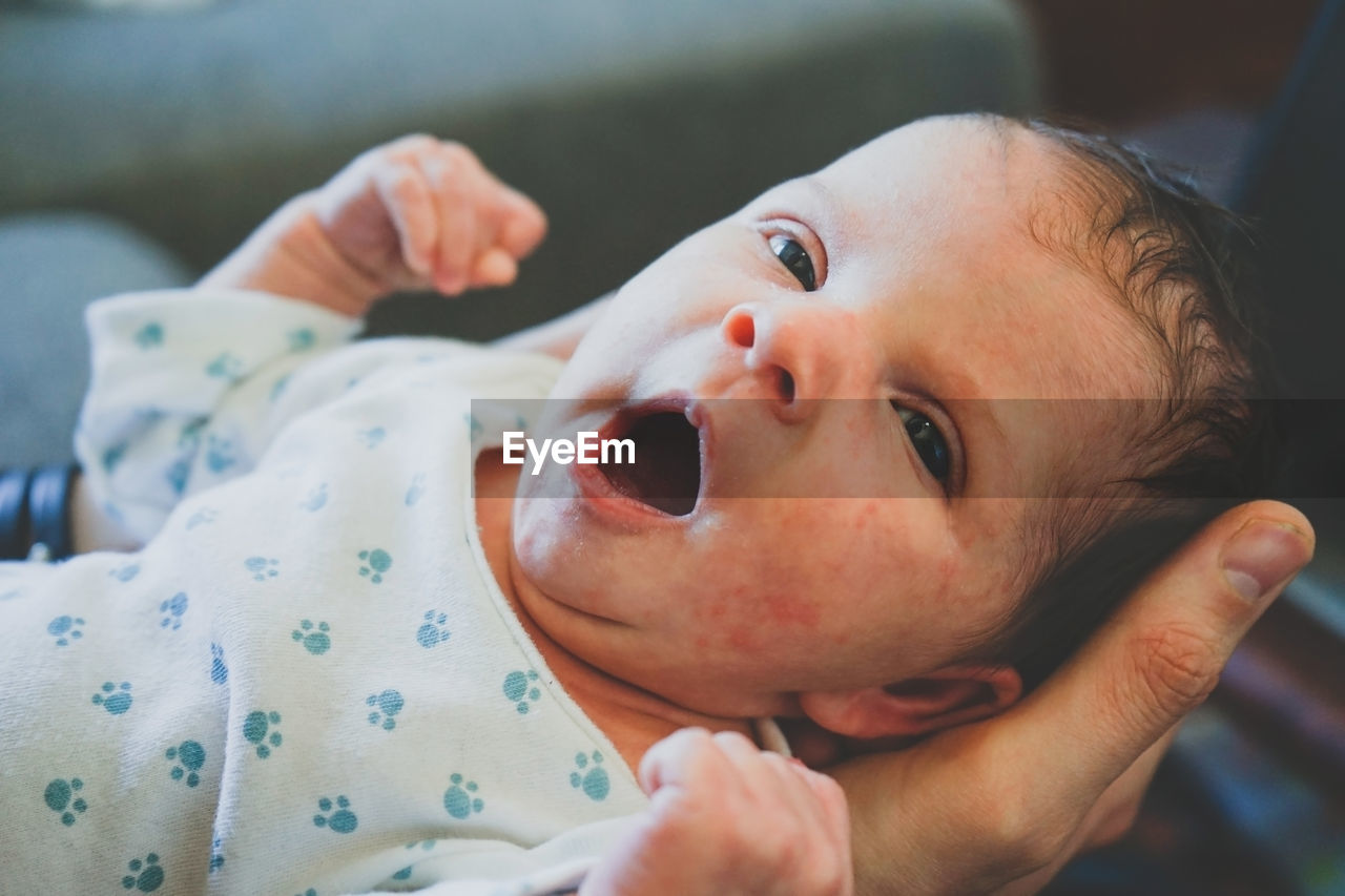 Portrait of cute baby girl on bed